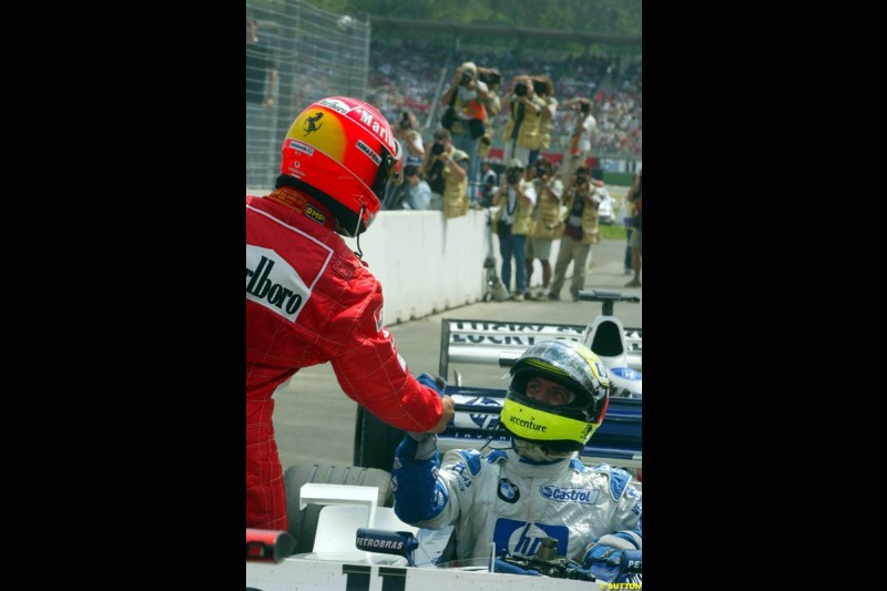 Michael Schumacher, Ferrari, congratulates brother Ralf Schumacher, Williams, after he claimed second place in Qualifying. German Grand Prix, Hockenheim, Germany, July 27th 2002.