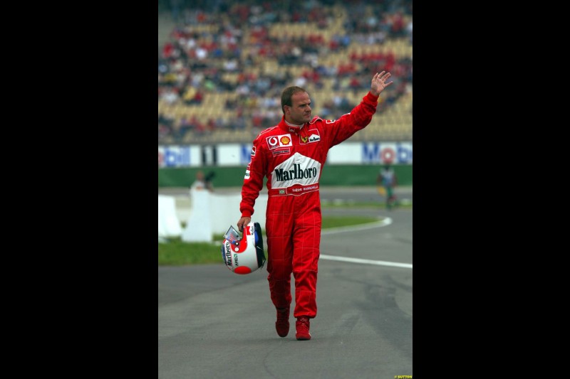 Rubens Barrichello, Ferrari, walks back to the pits after a spin during Saturday Free Practice. German Grand Prix, Hockenheim, Germany, July 27th 2002.