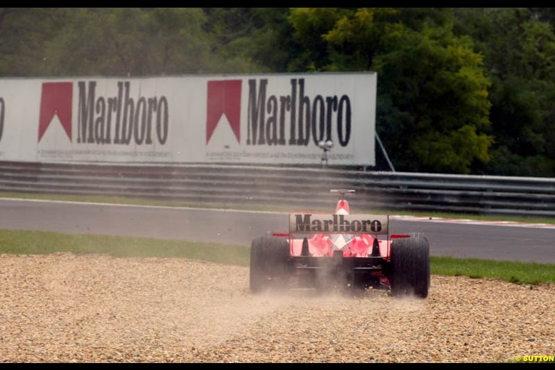 Rubens Barrichello (BRA) Ferrari F2002 runs into the gravel trap. Hungarian Grand Prix, Budapest, 16 August 2002.