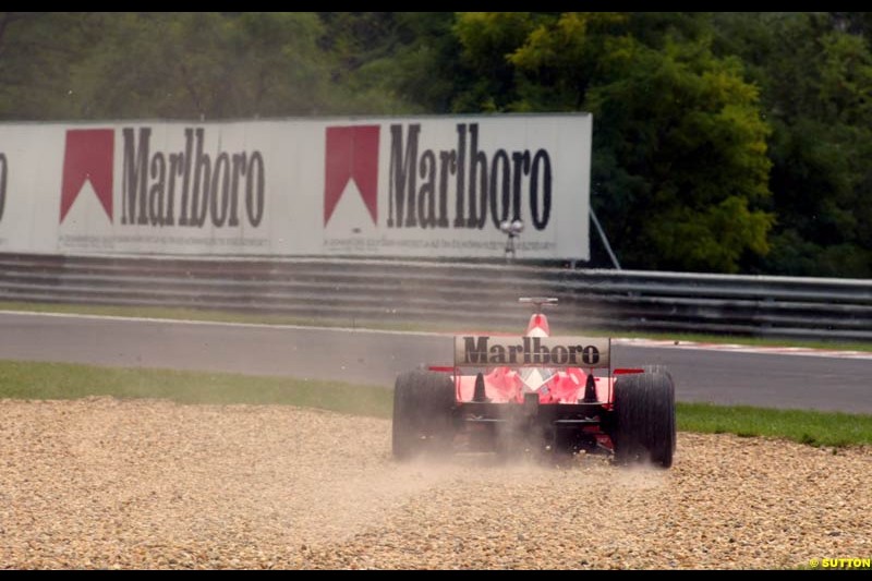 Rubens Barrichello (BRA) Ferrari F2002 runs into the gravel trap. Hungarian Grand Prix, Budapest, 16 August 2002. 