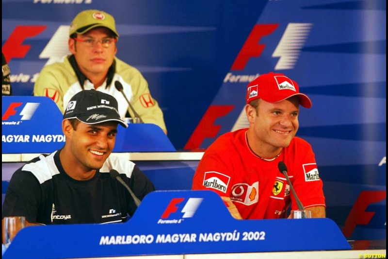 Good friends Rubens Barrichello, Ferrari, and Juan Pablo Montoya, Williams, share a joke during the FIA Thursday Press Conference. Hungarian Grand Prix, Budapest, Hungary, August 15th 2002.