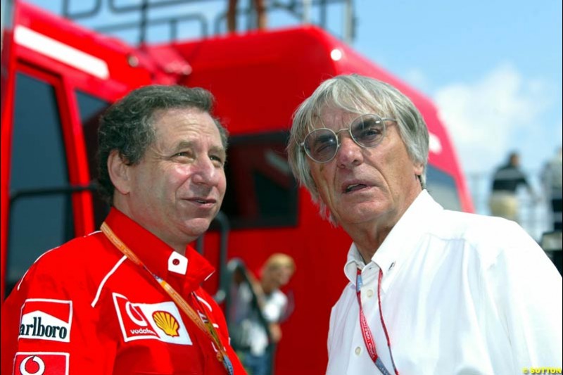 Jean Todt, Ferrari Director, chats to Bernie Ecclestone, F1 Supremo, during Qualifying, Hungarian Grand Prix, Budapest, August 17 2002.