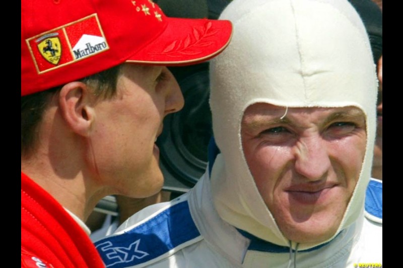Michael Schumacher (2nd), Ferrari, talks to Ralf Schumacher (3rd), Williams, after qualifying. Hungarian Grand Prix, Budapest, August 17 2002.