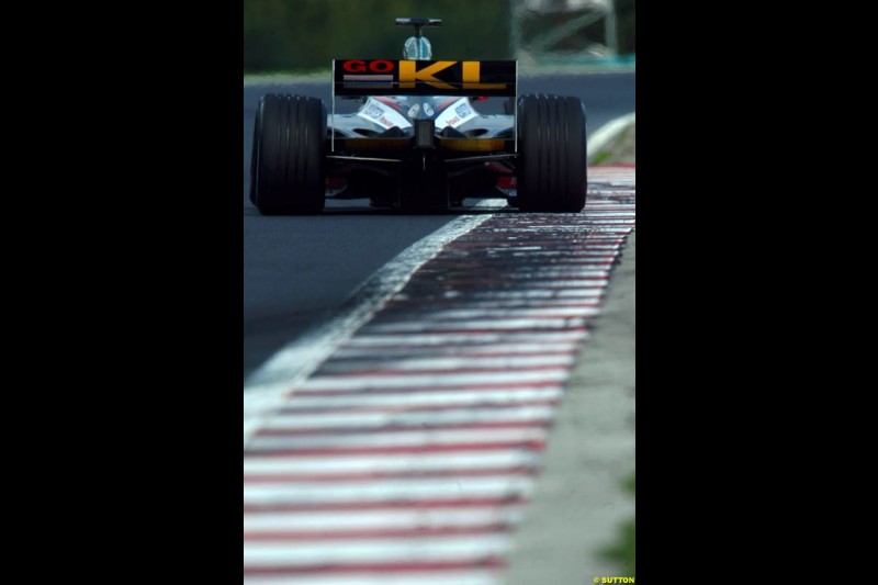 A Minardi rides the curb, during Saturday free practice, Hungarian Grand Prix, Budapest, August 17 2002.