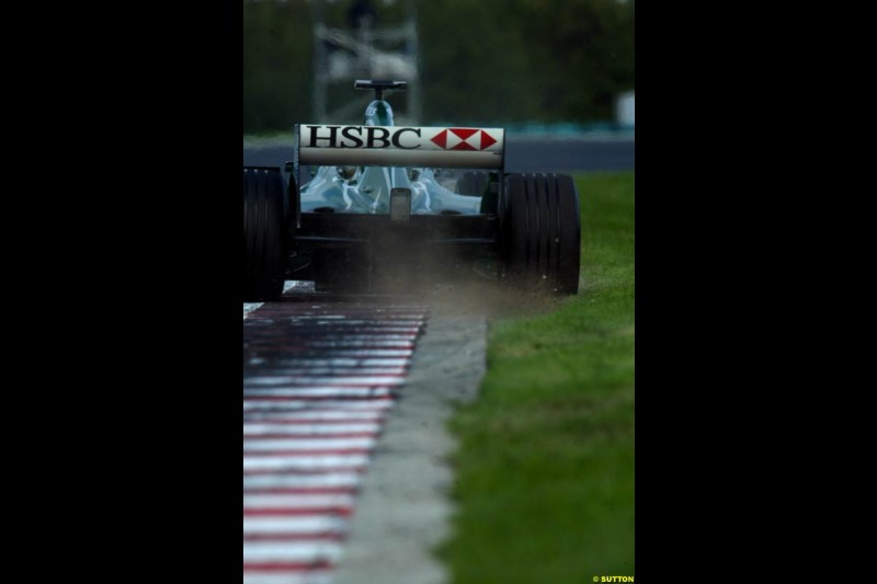 A Jaguar rides the curb, during Saturday free practice, Hungarian Grand Prix, Budapest, August 17 2002.
