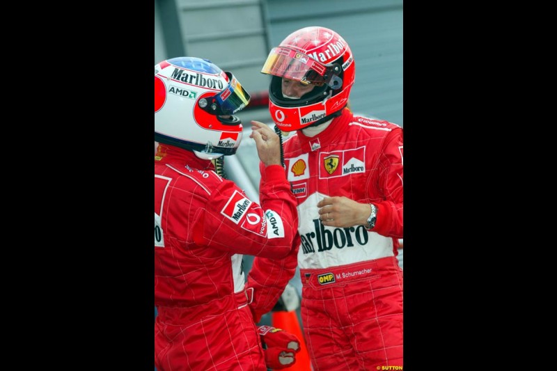 Michael Schumacher, Ferrari, chats to team mate Rubens Barrichello after qualifying. Belgian Grand Prix, Spa-Francorchamps, Belgium, August 31st 2002.