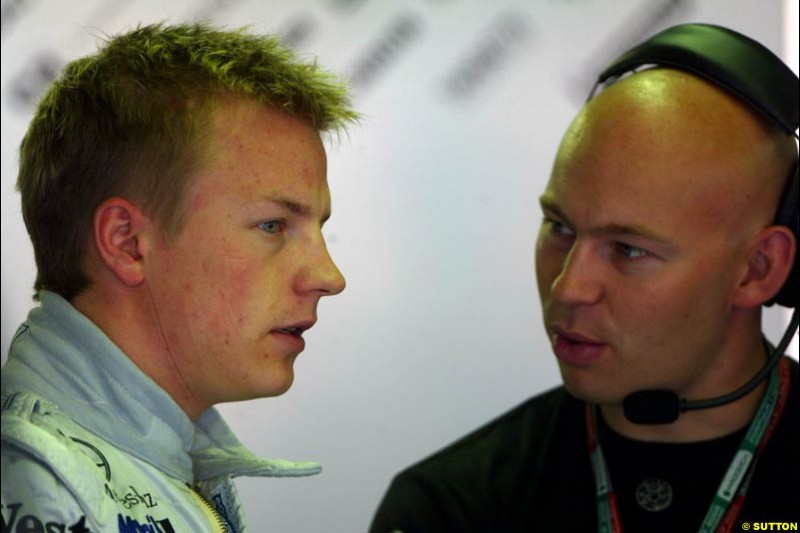 Kimi Raikkonen chats to his fitness advisor during Saturday Free Practice. Belgian Grand Prix, Spa-Francorchamps, Belgium, August 31st 2002.