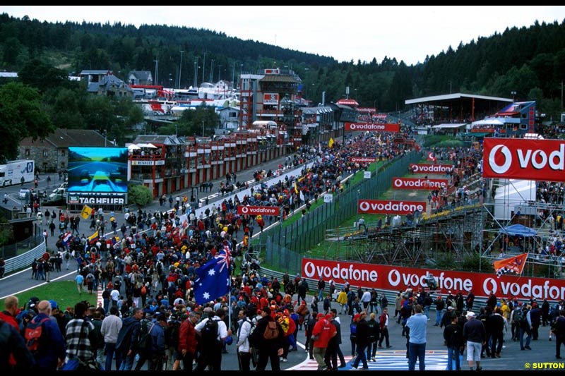 Fans stream down Eau Rouge at the end of the race. Belgian Grand Prix, Spa-Francorchamps, Belgium, September 1st 2002.