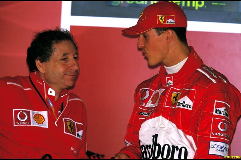 Jean Todt, Ferrari Director, chats to Michael Schumacher. Belgian Grand Prix, Spa-Francorchamps, Belgium, September 1st 2002.