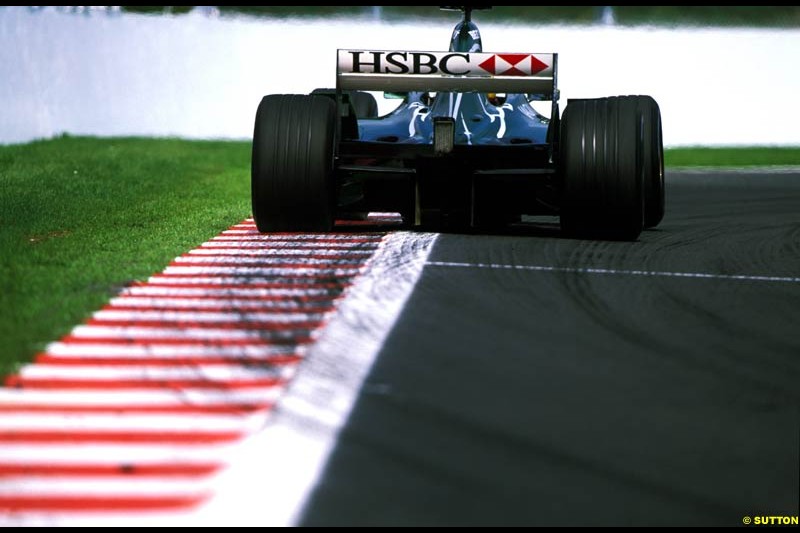 A Jaguar rides the curb. Belgian Grand Prix, Spa-Francorchamps, Belgium, September 1st 2002. 
