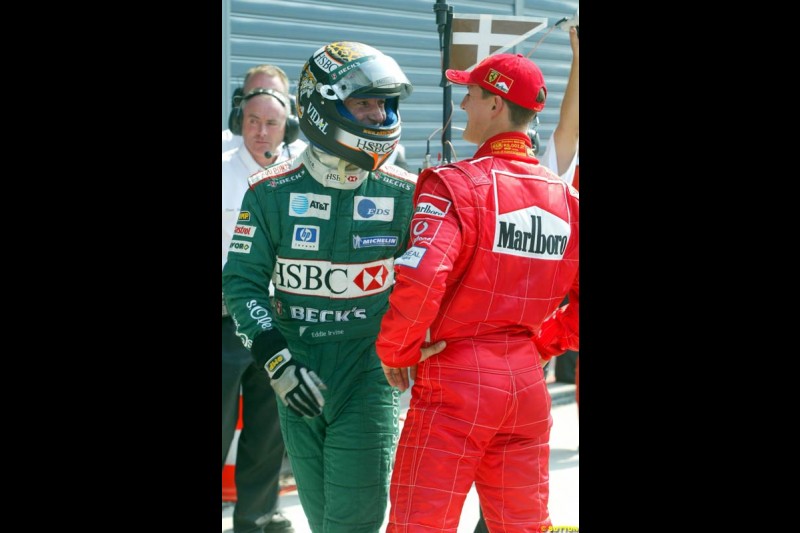 Eddie Irvine, Jaguar, with Michael Schumacher, Ferrari. Italian Grand Prix, Monza, Italy. September 14th 2002.
