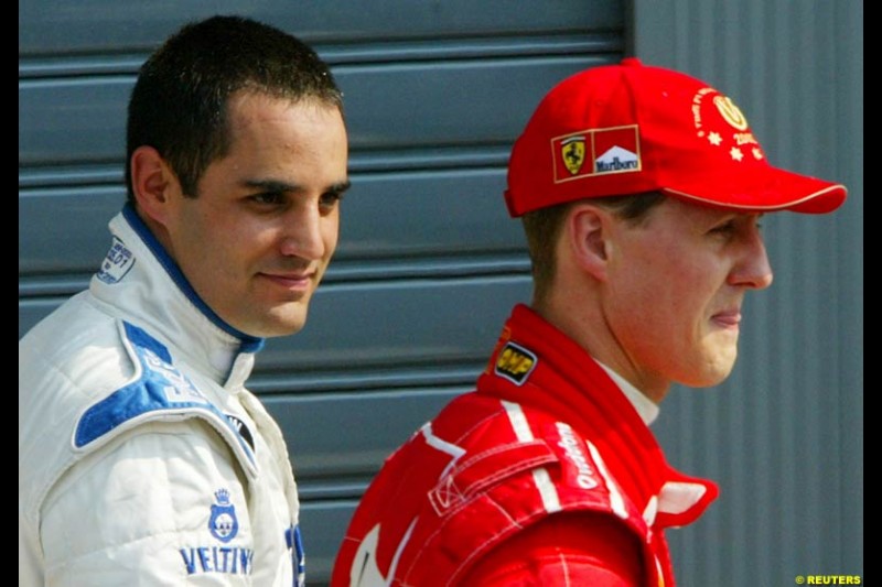 Juan Pablo Montoya, Williams, with Michael Schumacher, Ferrari, post Qualifying. Italian Grand Prix, Monza, Italy. September 14th 2002. 
