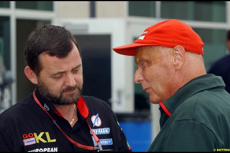 Minardi's Paul Stoddart and Jaguar's Niki Lauda at the Indianapolis Motor Speedway, United States GP, Indianapolis, September 26th 2002.