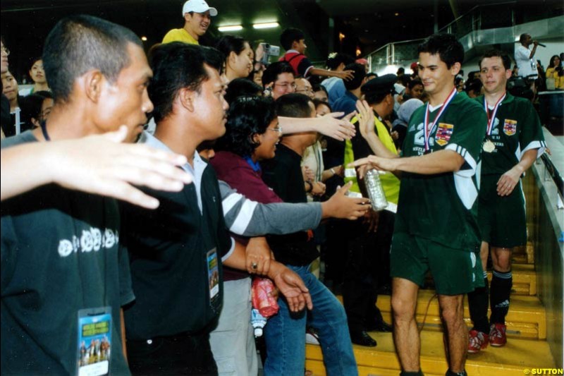 Alex Yoong takes part in a charity football match with Irish boy band Westlife. Malaysia, Kuala Lumpur, 30 October 2002.