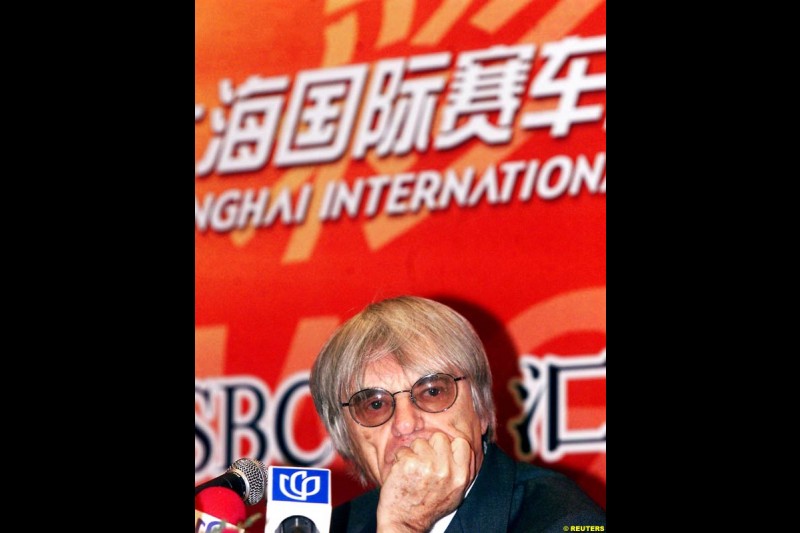 Formula One chief Bernie Ecclestone and Juan Wei, Deputy Manager of the Shanghai International Circuit Co Ltd, sign documents at a ceremony in Shanghai, China, October 21, 2002. Ecclestone signed an agreement to help the city host F1 Grand Prix races from 2004 to 2010.