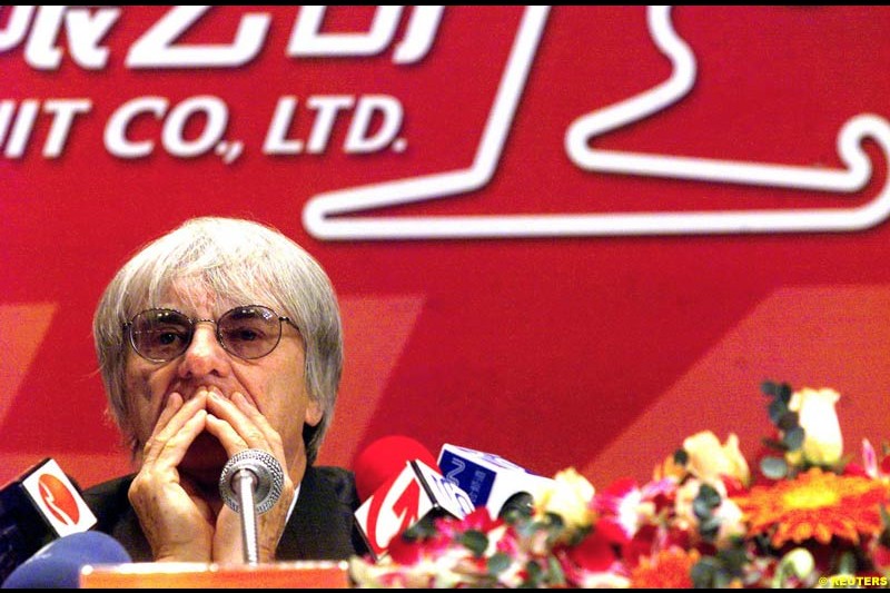 Formula One chief Bernie Ecclestone and Juan Wei, Deputy Manager of the Shanghai International Circuit Co Ltd, sign documents at a ceremony in Shanghai, China, October 21, 2002. Ecclestone signed an agreement to help the city host F1 Grand Prix races from 2004 to 2010.