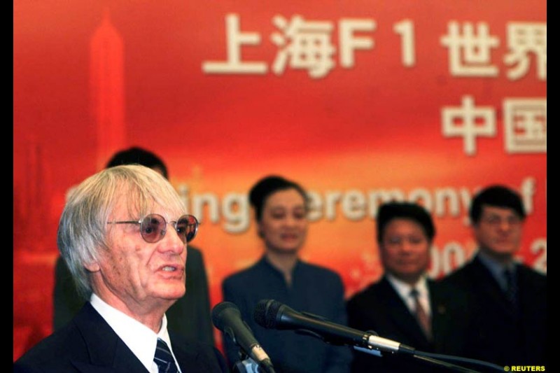 Formula One chief Bernie Ecclestone and Juan Wei, Deputy Manager of the Shanghai International Circuit Co Ltd, sign documents at a ceremony in Shanghai, China, October 21, 2002. Ecclestone signed an agreement to help the city host F1 Grand Prix races from 2004 to 2010. 