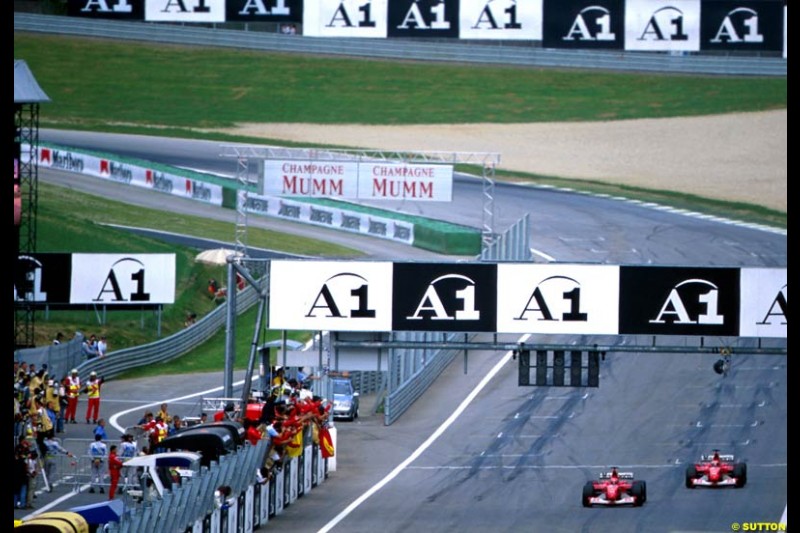 Michael Schumacher, Ferrari, passes team mate Rubens Barrichello at the final corner to win the Austrian Grand Prix, Round 6.