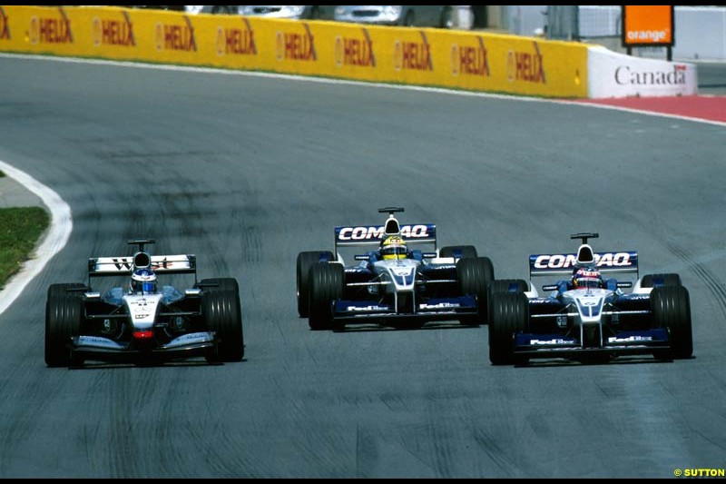 Juan Pablo Montoya, Williams, passes team mate Ralf Schumacher, Williams, and Kimi Raikkonen, McLaren, during the Canadian Grand Prix, Round 8.