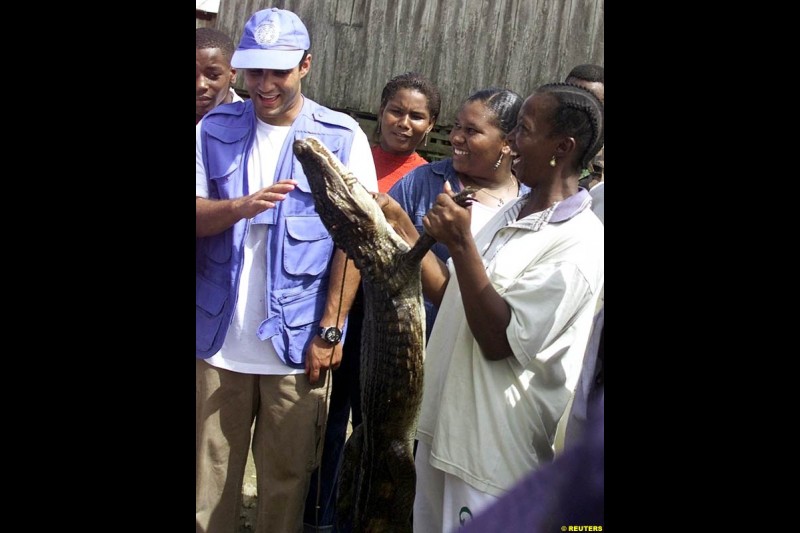 Juan Pablo Montoya during a visit at the impoverished village of Napipi, in northwestern Choco Province, November 22, 2002. Choco is one of Colombia's poorest regions and is hard hit by a 38-year old guerrilla war that kills thousands of people every year. Montoya is visiting Napipi as part of a campaign to donate money to poor children.