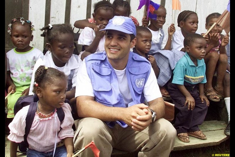 Juan Pablo Montoya during a visit at the impoverished village of Napipi, in northwestern Choco Province, November 22, 2002. Choco is one of Colombia's poorest regions and is hard hit by a 38-year old guerrilla war that kills thousands of people every year. Montoya is visiting Napipi as part of a campaign to donate money to poor children.