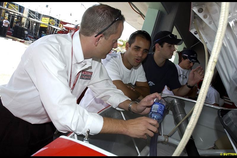 Juan Pablo Montoya chats with the Ganassi crew at the final race of the NASCAR season. Ford 400, Homestead, Florida USA. November 16th 2002.