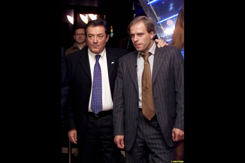 Russian Formula One driver Sergei Zlobin (R) and Minardi managing director Giancarlo Minardi pose for photographers at a night club in Moscow late November 14, 2002.