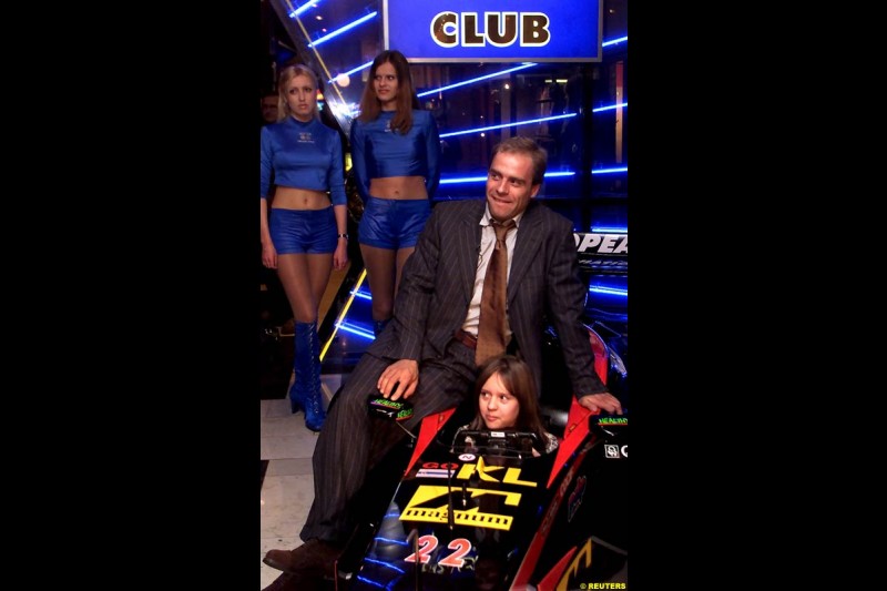 Russian Formula One driver Sergei Zlobin poses for photographers in a night club in Moscow late November 14, 2002.