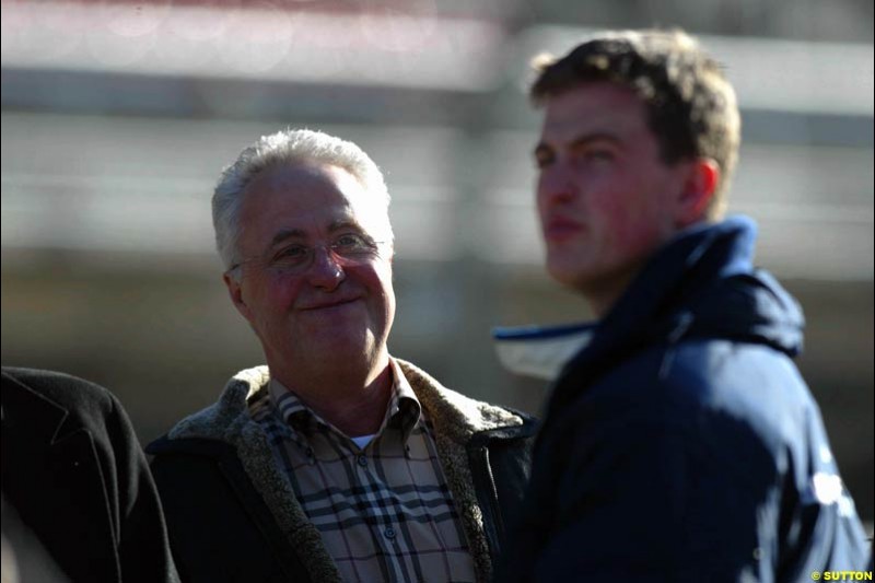 Rolf Schumacher stands next to son Ralf Schumacher, Williams, during testing at the Circuit de Catalunya. Barcelona, Spain. February 1st-5th, 2003.