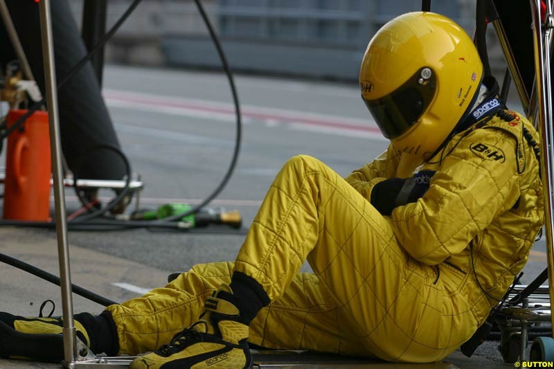 Jordan mechanic takes a rest during testing at Barcelona, Spain. 18th February 2003.