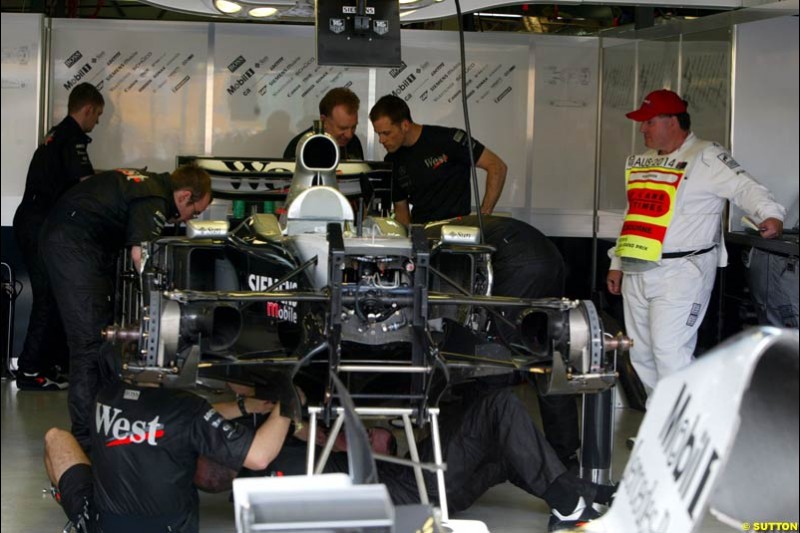 The McLaren mechanics work in Parc Ferme under the watchful eyes of the scrutineers after qualifying for the Australian GP. Melbourne, March 8th 2003.