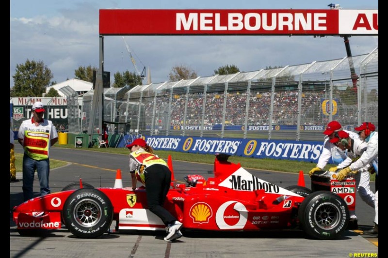 Michael Schumacher's Ferrari pushed to the Parc Ferme garage after Saturday's qualifying for the Australian GP. Melbourne, March 8th 2003.