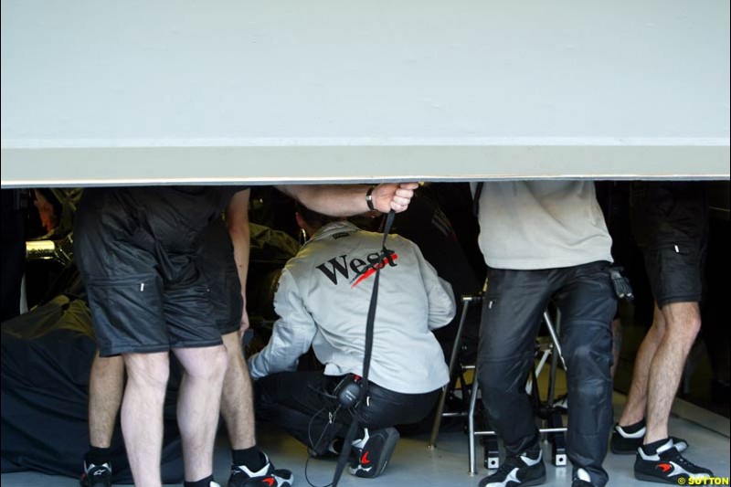 McLaren work on Kimi Raikkonen's McLaren in the garage during Saturday practice. Australian GP, Melbourne. March 8th 2003.
