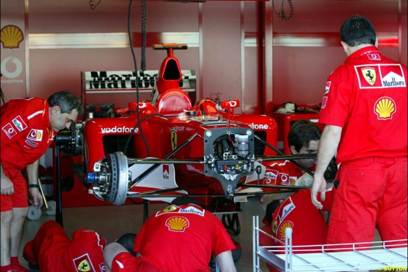 Ferrari working on Michael Schumacher's damaged car. Saturday practice. Australian GP, Melbourne. March 8th 2003.