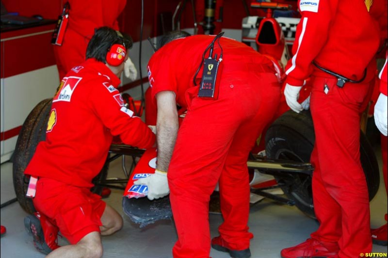 Ferrari working on Michael Schumacher's damaged car. Saturday practice. Australian GP, Melbourne. March 8th 2003.