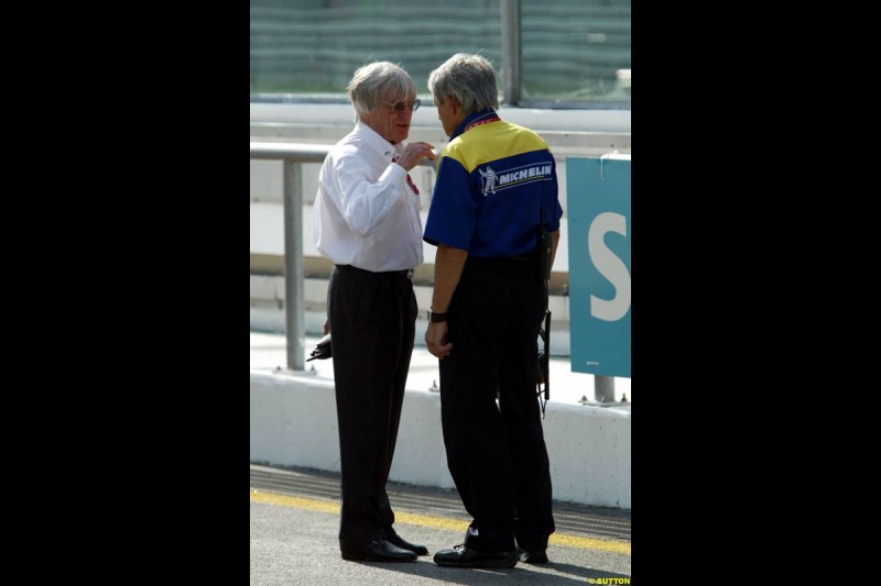 Bernie Ecclestone with Pierre Dupasquier, Michelin, during Friday morning testing at Sepang International Circuit. Malaysian GP, March 21st 2003.