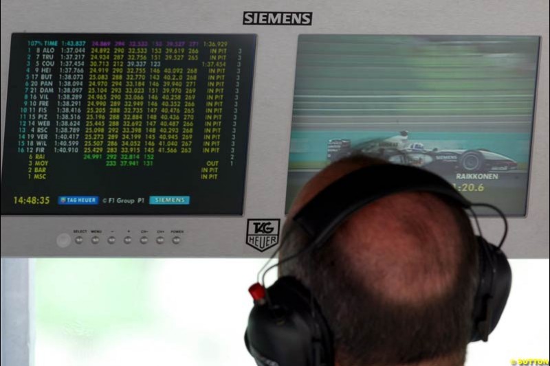 Ron Dennis, McLaren, watches his driver Kimi Raikkonen during Saturday qualifying for the Malaysian GP. Sepang, March 22nd 2003.