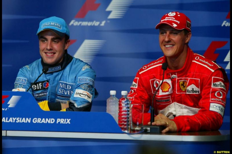 Fernando Alonso, Renault, and Michael Schumacher, Ferrari, at the Post qualifying press conference. Saturday, Malaysian GP. Sepang, March 22nd 2003.