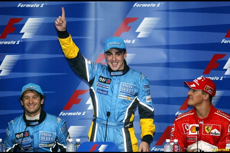 Fernando Alonso, Renault, pleased with his first pole position. Press conference after Fernando Alonso, Flavio Briatore and Jarno Trulli celebrate Renault's front row. Saturday qualifying for the Malaysian GP. Sepang, March 22nd 2003.