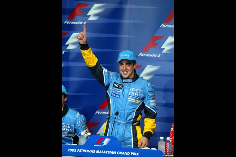 Fernando Alonso, Renault, pleased with his first pole position. Press conference after Fernando Alonso, Flavio Briatore and Jarno Trulli celebrate Renault's front row. Saturday qualifying for the Malaysian GP. Sepang, March 22nd 2003.