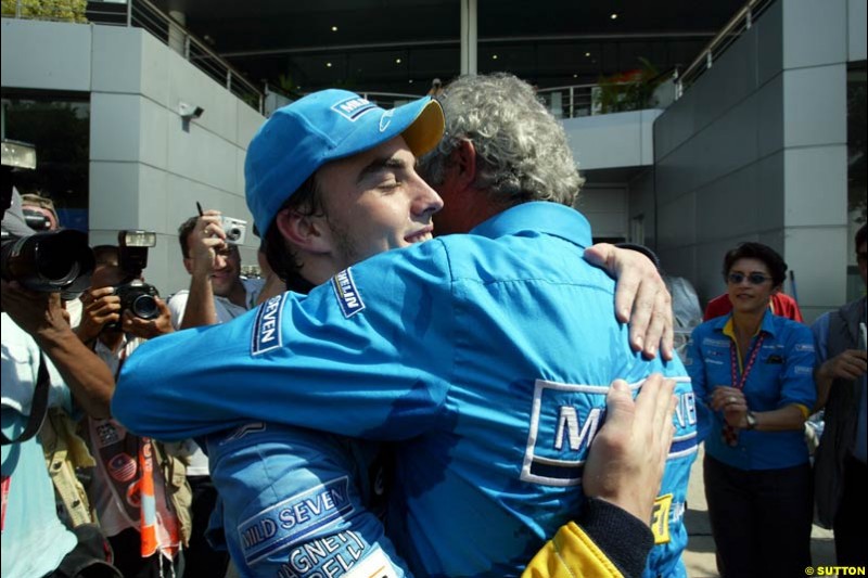 Fernando Alonso and Flavio Briatore celebrate Renault's front row. Saturday qualifying for the Malaysian GP. Sepang, March 22nd 2003.