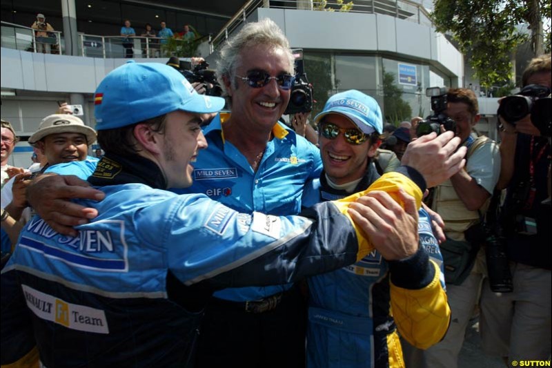 Fernando Alonso, Flavio Briatore and Jarno Trulli celebrate Renault's front row. Saturday qualifying for the Malaysian GP. Sepang, March 22nd 2003.