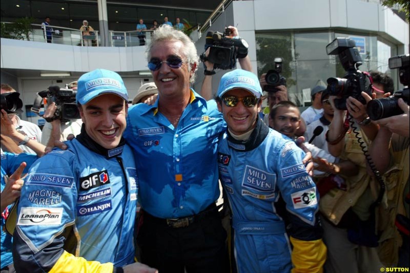 Fernando Alonso, Flavio Briatore and Jarno Trulli celebrate Renault's front row. Saturday qualifying for the Malaysian GP. Sepang, March 22nd 2003.