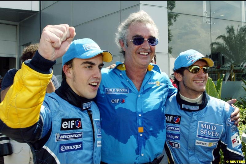 Fernando Alonso, Flavio Briatore and Jarno Trulli celebrate Renault's front row. Saturday qualifying for the Malaysian GP. Sepang, March 22nd 2003.