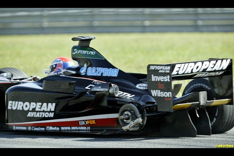 Justin Wilson, Minardi, loses a tyre during Saturday practice for the Malaysian GP. Sepang, March 22nd 2003.