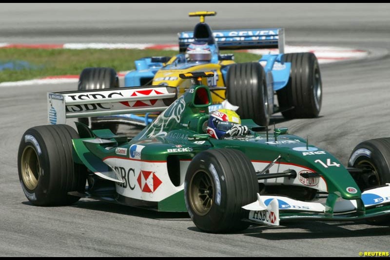 Mark Webber, Jaguar, followed by Jarno Trulli, Renault, during Saturday practice for the Malaysian GP. Sepang, March 22nd 2003.