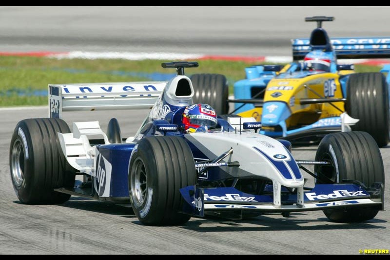 Juan Pablo Montoya, Williams, followed by Fernando Alonso, Renault, during Saturday practice for the Malaysian GP. Sepang, March 22nd 2003.