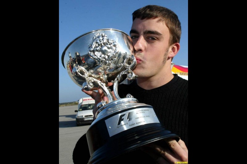 Fernando Alonso with his third place trophy from the Brazilian GP. April 8th 2003.