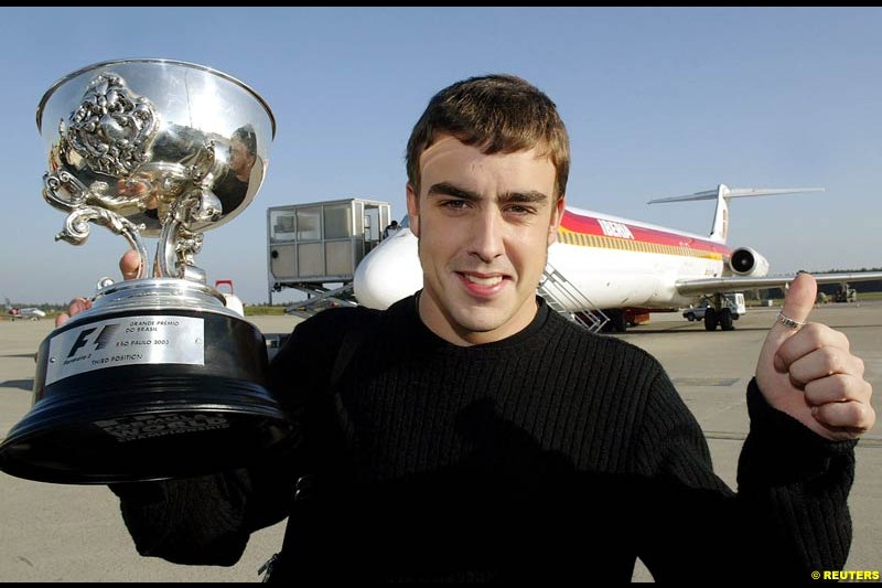 Fernando Alonso with his third place trophy from the Brazilian GP. April 8th 2003.