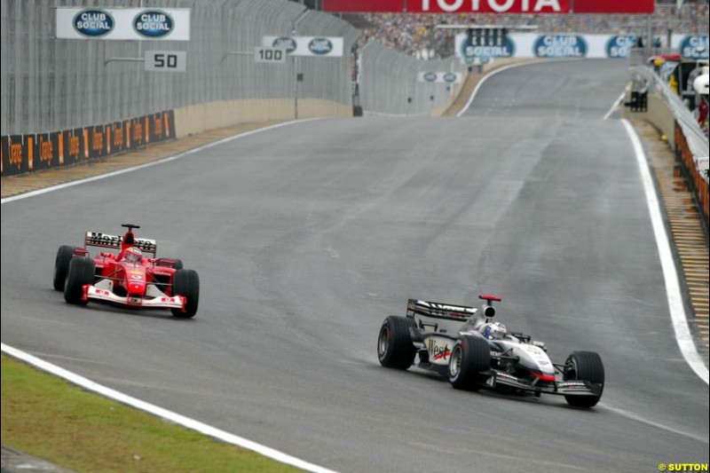David Coulthard, McLaren, leads Rubens Barrichello, Ferrari, during the Brazilian Grand Prix. Interlagos, Sao Paulo, April 6th 2003.